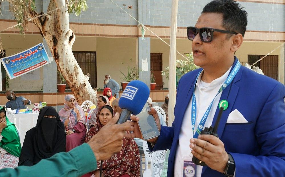 Reporter holding a handheld microphone outdoors